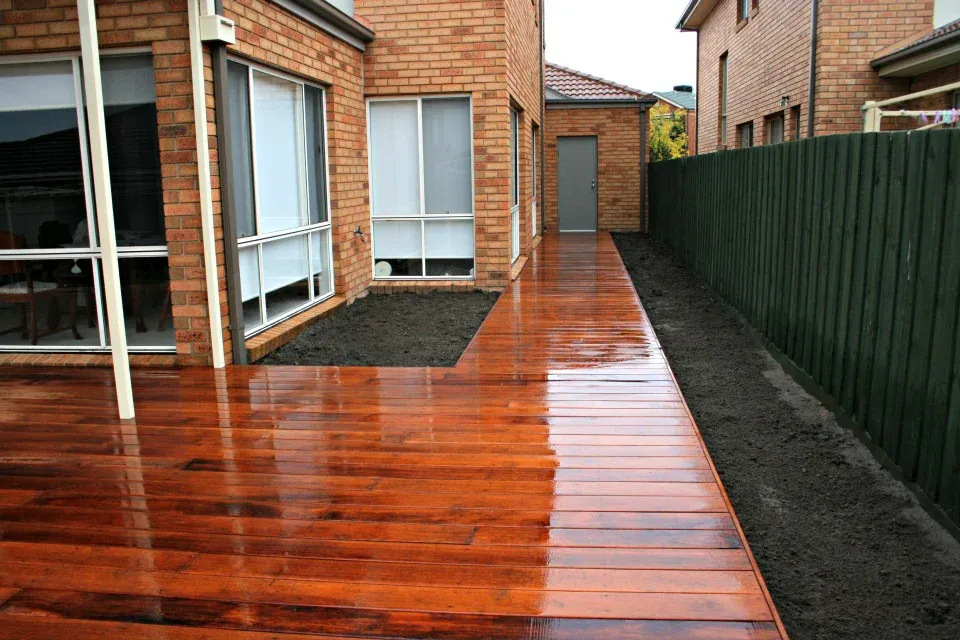 Freshly oiled merbau deck running along a side path